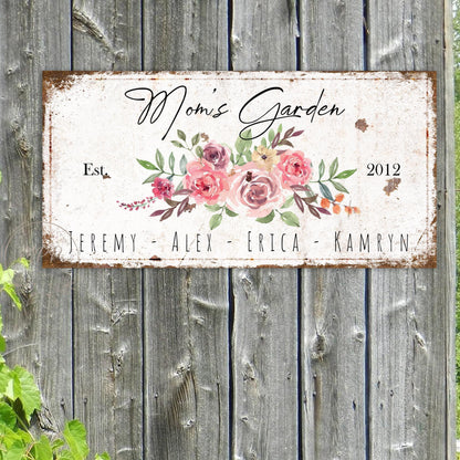 May include: White metal sign with a floral design and the text "Mom's Garden Est. 2012" and the names "Jeremy, Alex, Erica, Kamryn".