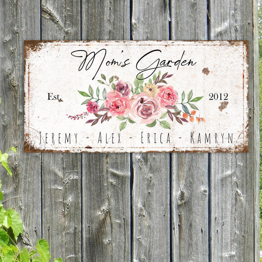 May include: White metal sign with a floral design and the text "Mom's Garden Est. 2012" and the names "Jeremy, Alex, Erica, Kamryn".