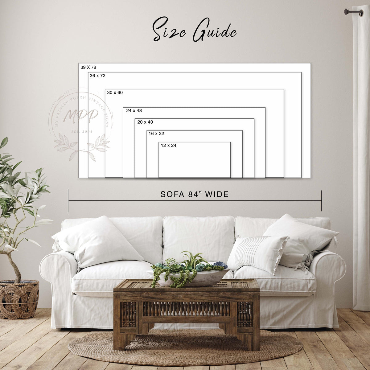 a living room with a white sofa, a wooden coffee table, and a potted plant. Above the sofa, there is a large size guide that provides dimensions for the sofa in inches. The sofa is described as being 84 inches wide.